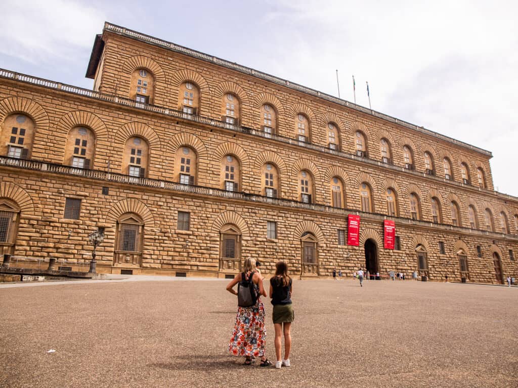 woman and girl standing outside Pitti palace in Florence