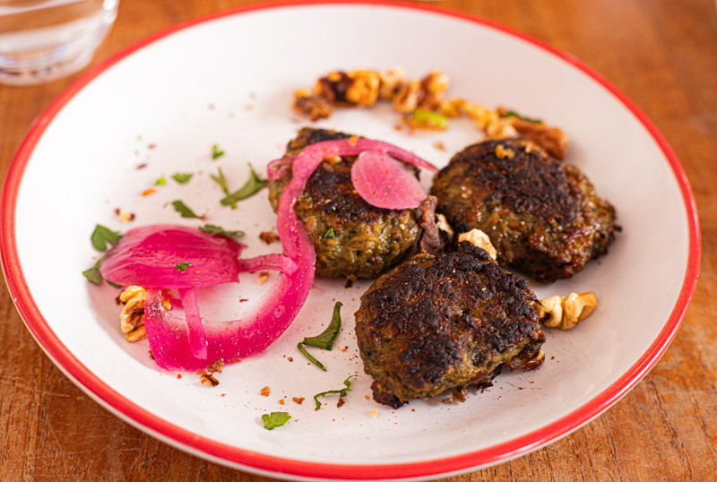 pork mini burgers on plate with pickled onion