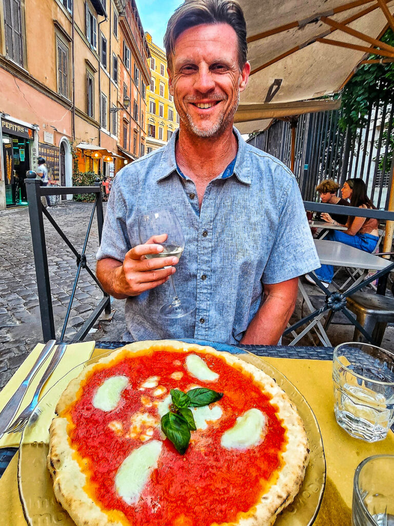 Man eating pizza in Rome