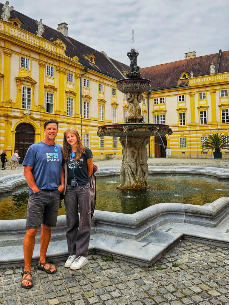 craig and kalyra posing in front of fountain in melk abbey square