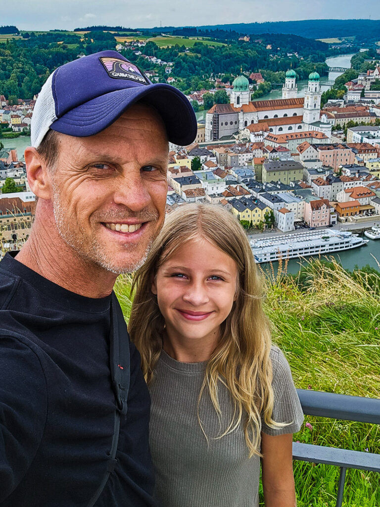 Dad and daughter with a city backdrop of Passau, Germany