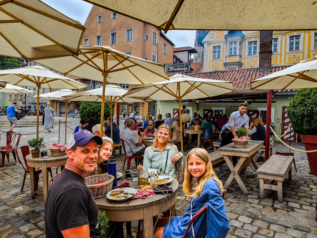 Family of four having lunch outside on tables in Germany