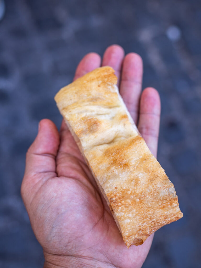 person holding white pizza in hand