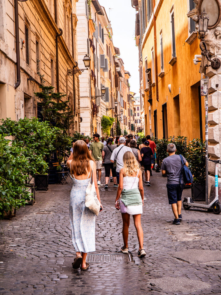 Girls walking along a cobblestone street in Rome