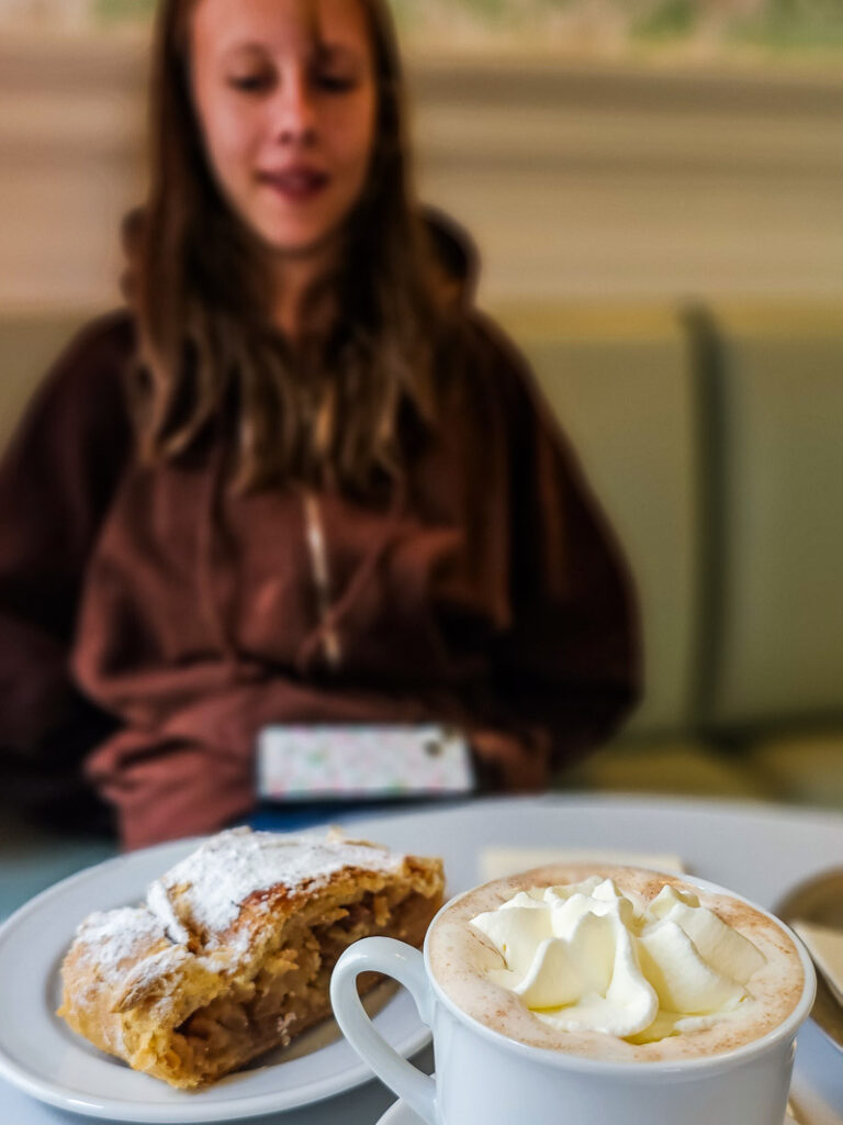 Girl looking at pastries and hot chocolate