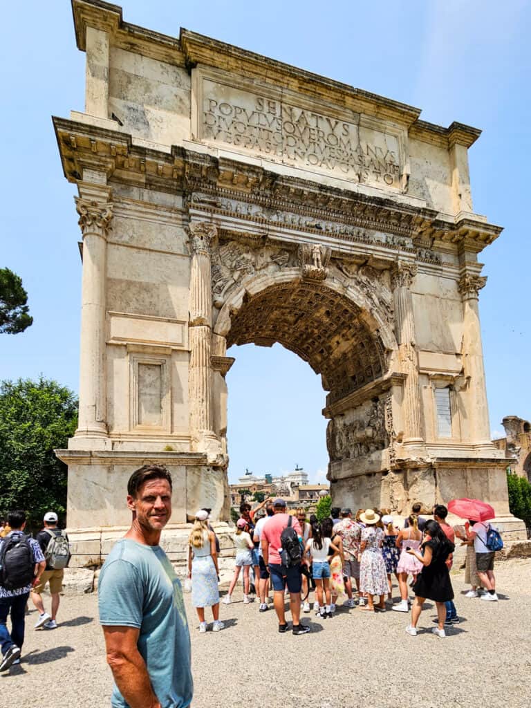 craig standing in front the huge marble arch of titus
