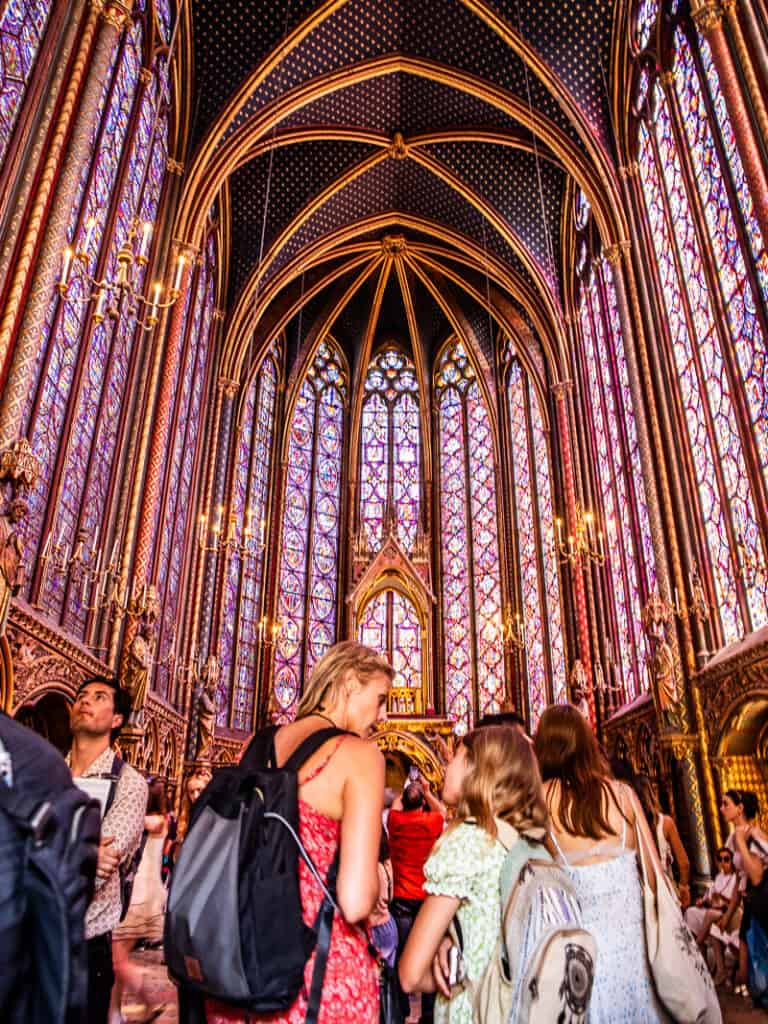 People inside a church that has incredible stained glass windows