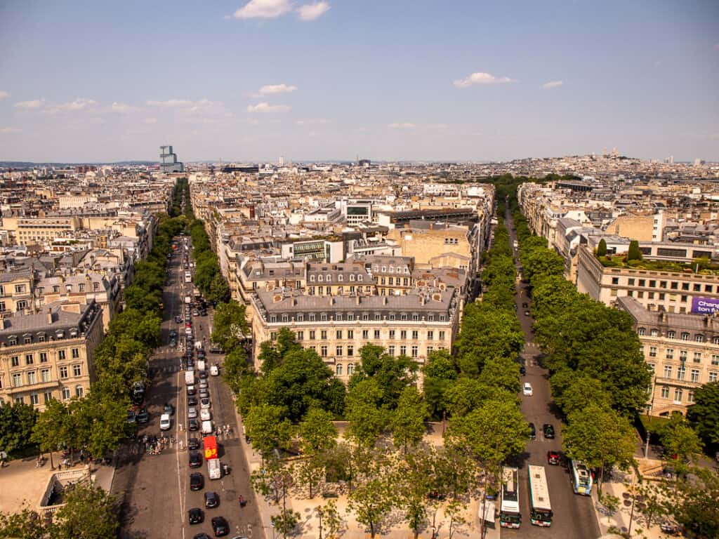 Aerial view of tree lined streets and cars driving through the city of Paris