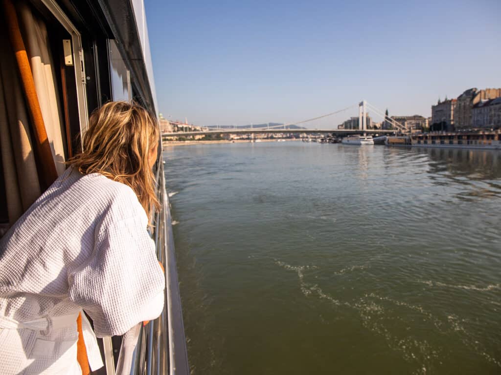 Woman leaning out of a window on a river cruise
