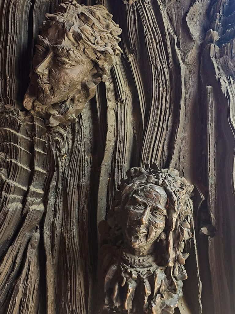carved heads on door