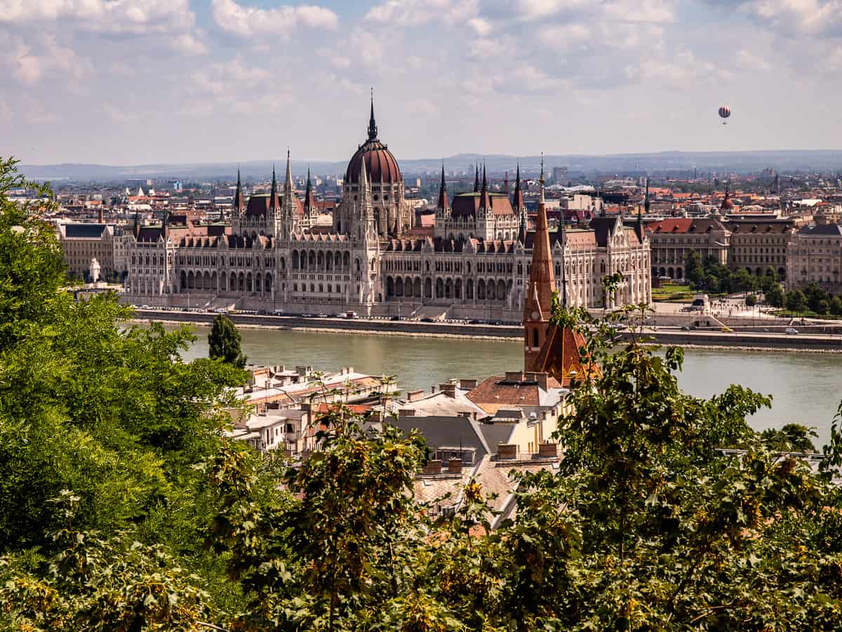 Distant view of a parliament building across a river
