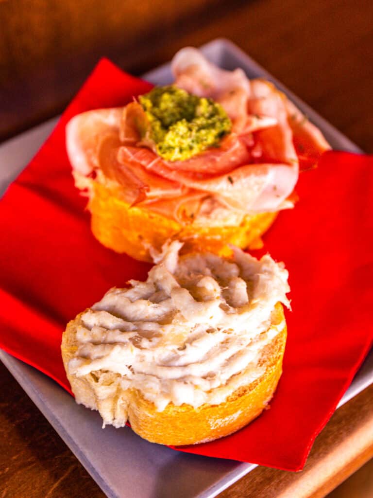 creamy fish and cured meats on chichetti on plate