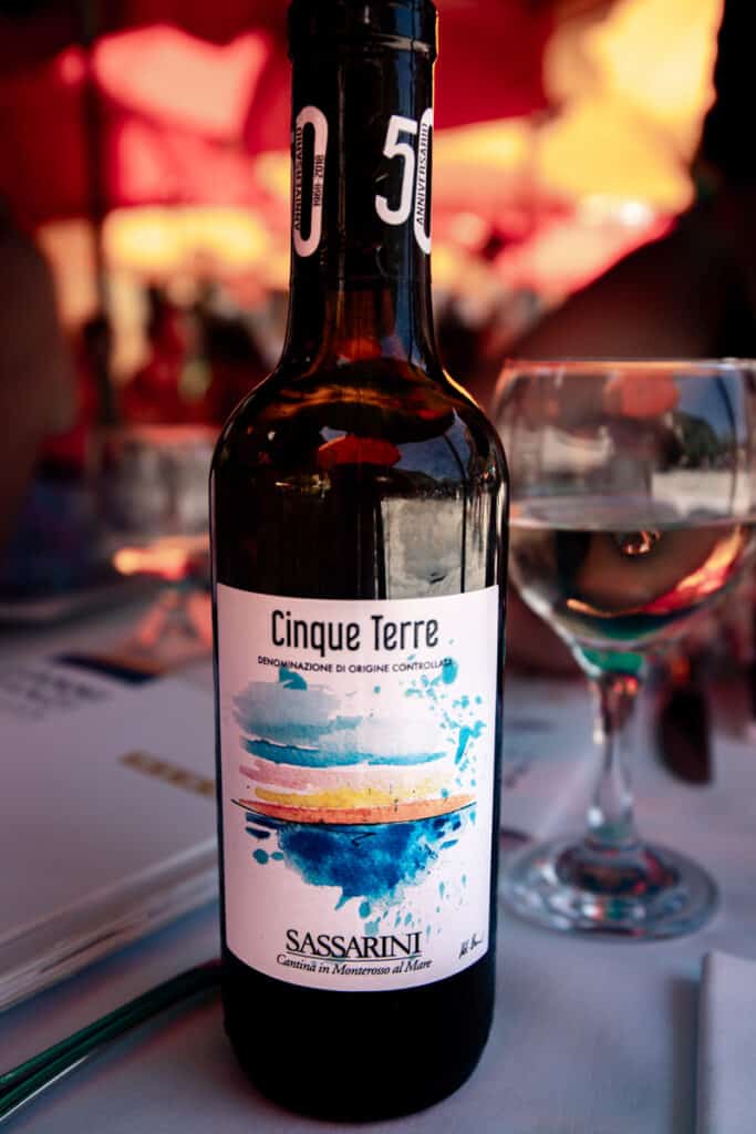 bottle of cinque terre wine on table next to glass
