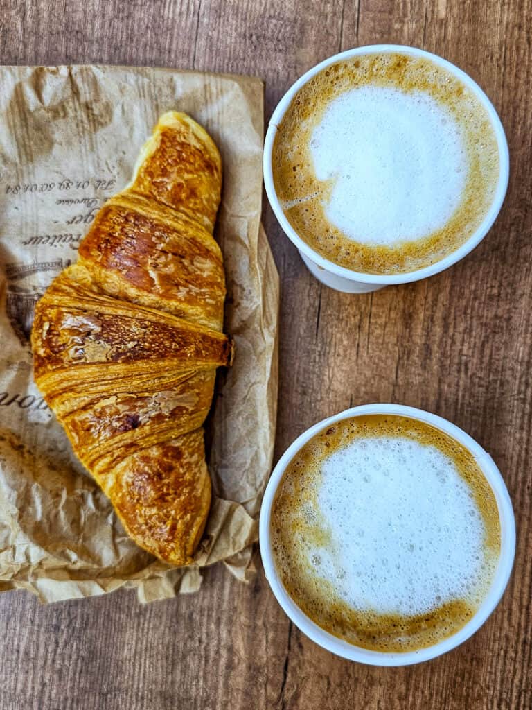 Two cups of coffee and croissant