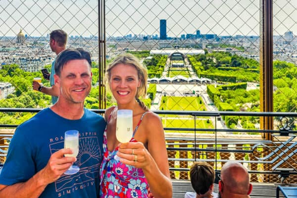 Man and lady drinking a glass of wine overlooking the cith view from Eiffel Tower