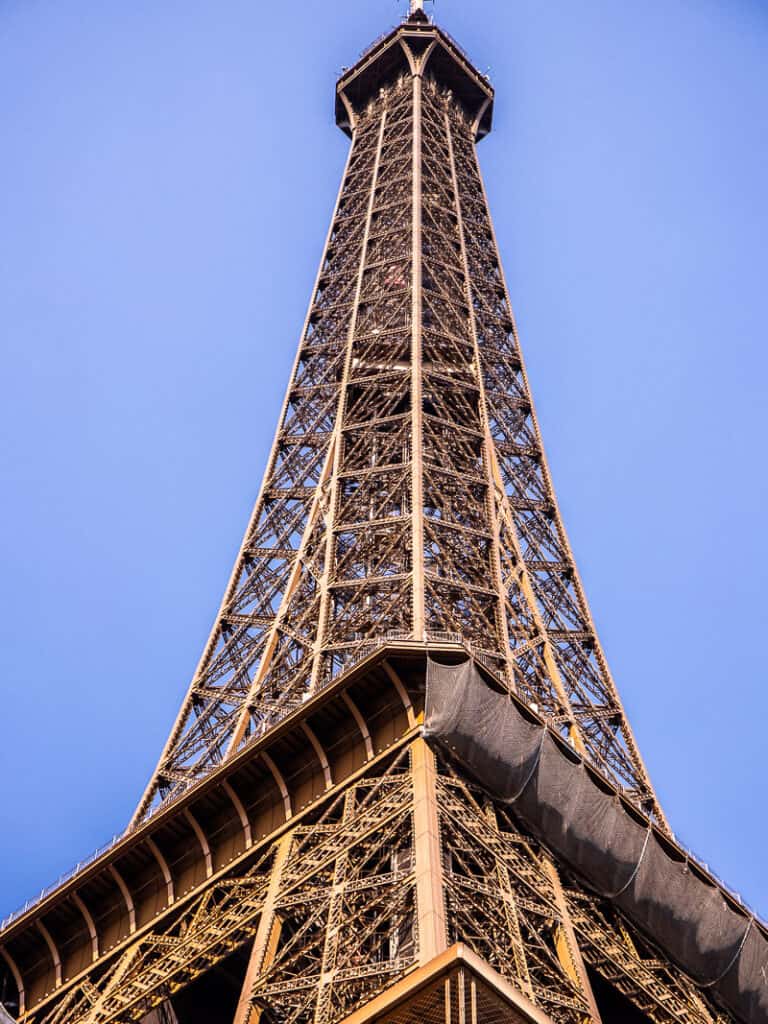 looking up at the top of the Eiffel Tower