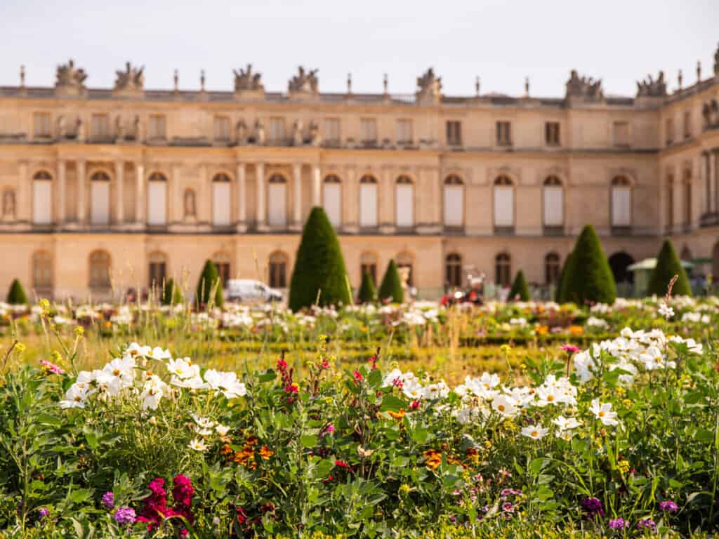 Palace of Versailles with flowers in front