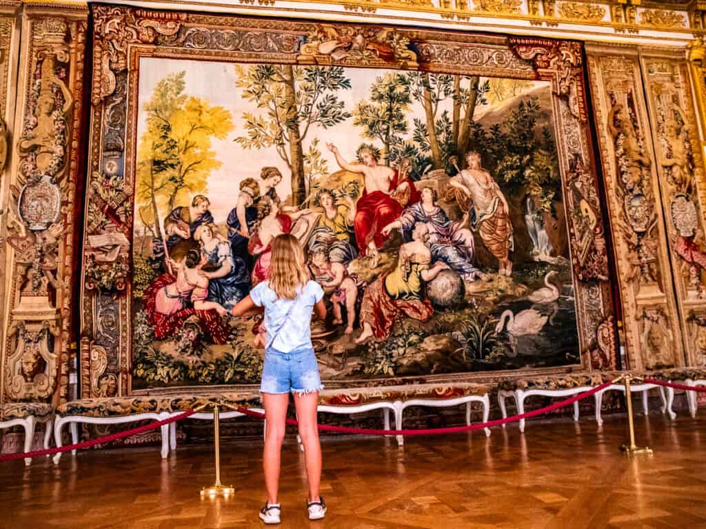 savannah looking at tapestry in palace of versaille