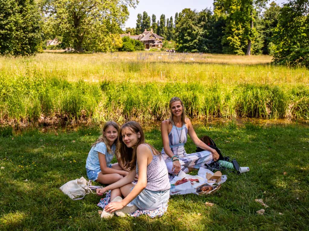 caz and girls having a picnic in front of queens hamlet versaille