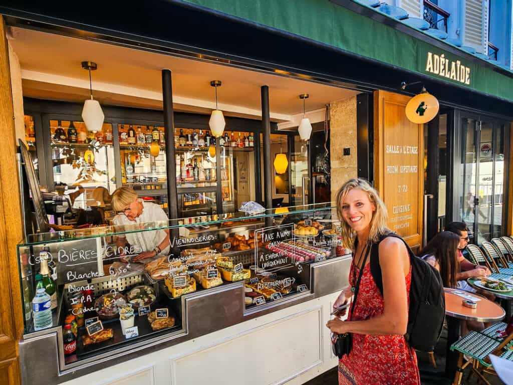Lady buying coffee and pastries from a cafe in Paris