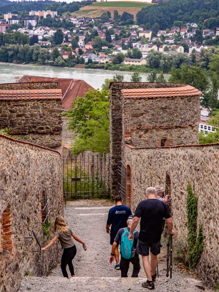 People walking down steps surrounded by stone walls