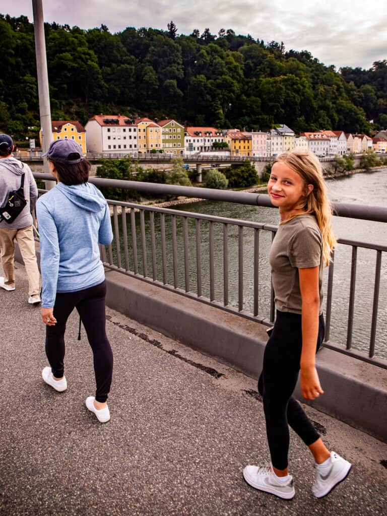 Girl walking across a bridge