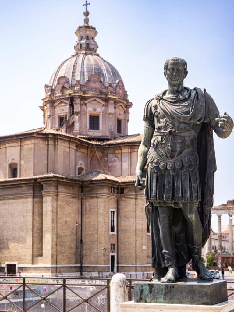 Julius Ceasar statue in front of dome building
