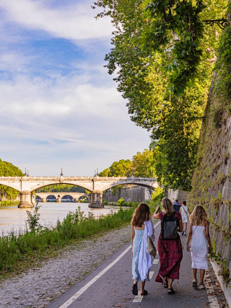 caz and girls walking along the tiber river rome