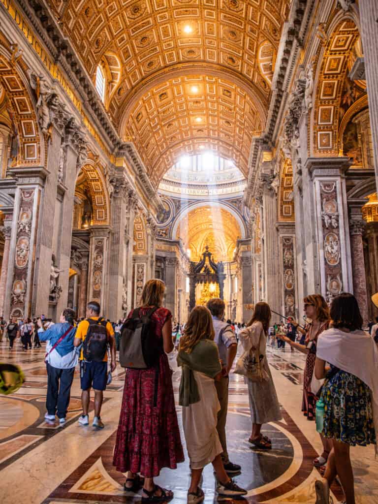 people inside st peter's basilica looking at its stunning design