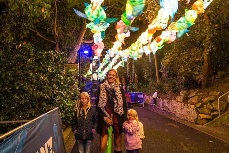 caz and girls standing under turtle lights at vivid