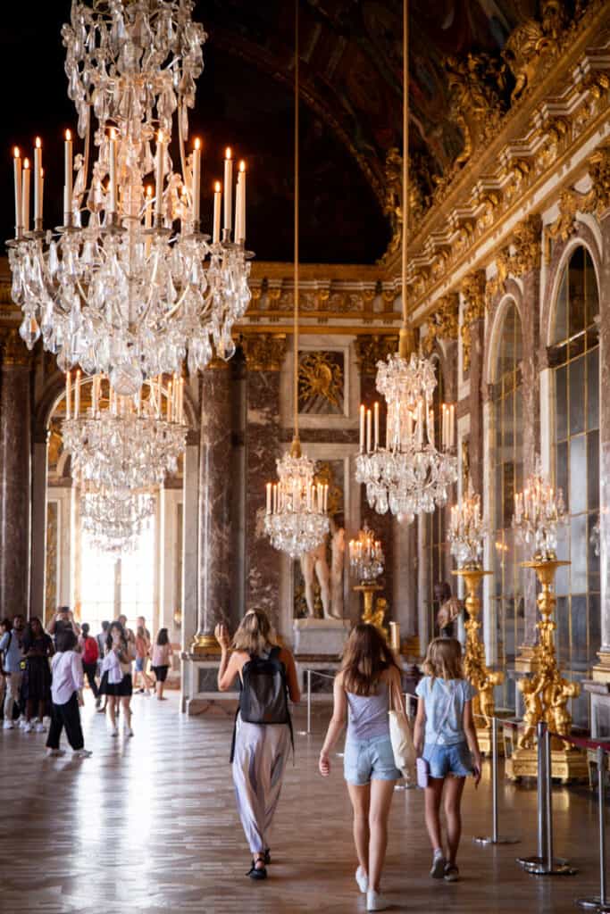 people walking through the hall of mirrors