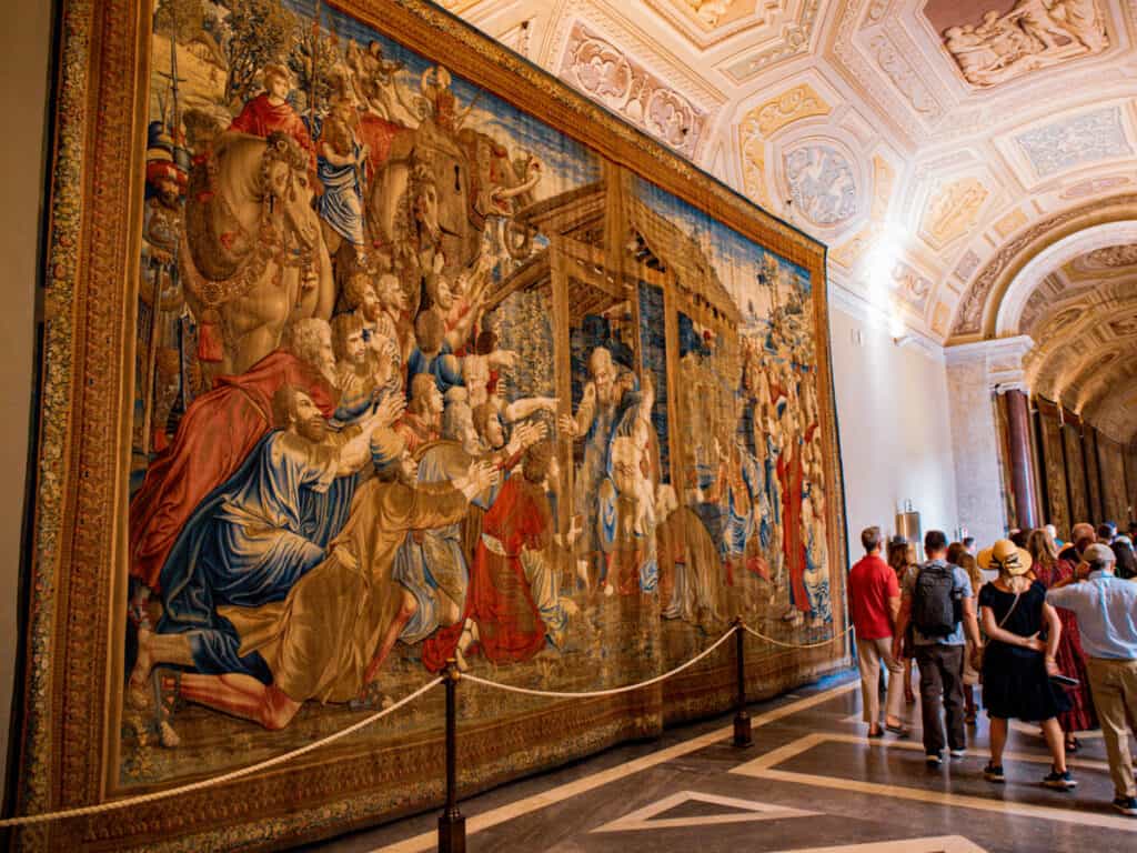 large tapestry on wall in gallery inside vatican museum