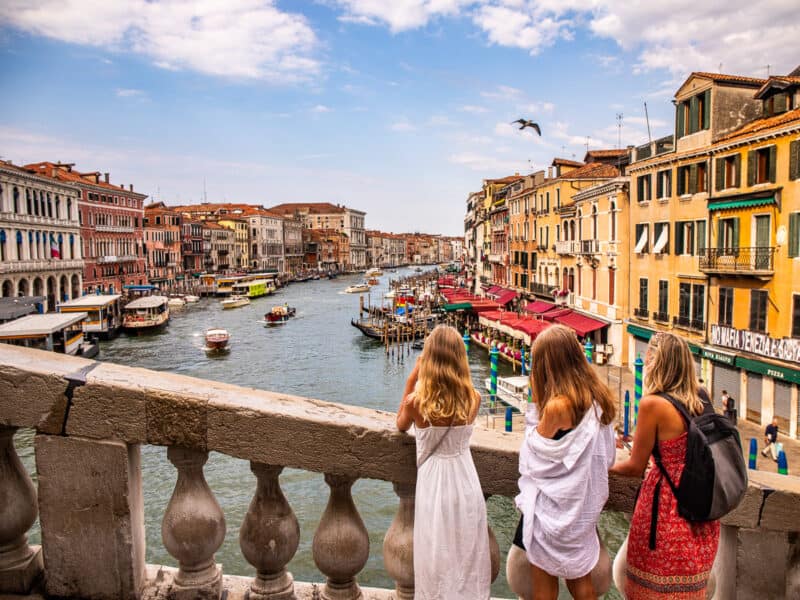 Mom and two daughters looking over a canal in Venice