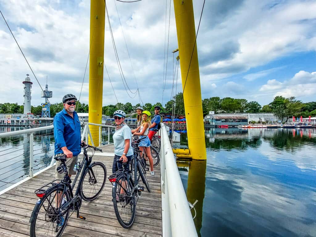 people corssing river bridge in vienna on bikes
