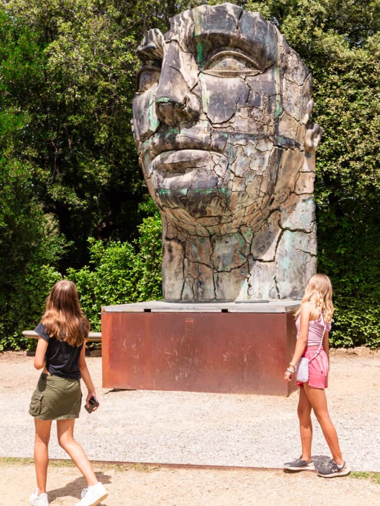 kalyra and savannah looking at statue of head