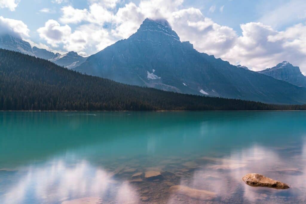 emerald water Chephren Lake with mountain in background