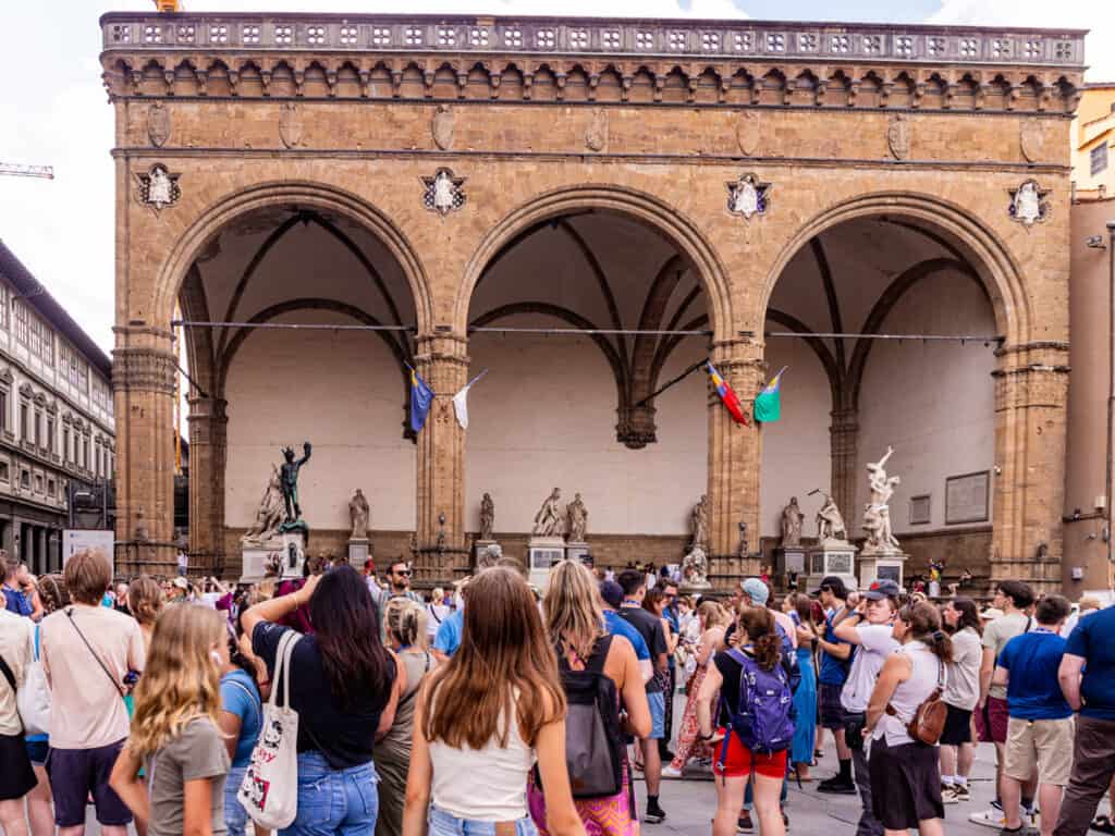 people liooking at statues in Piazza Signoria 