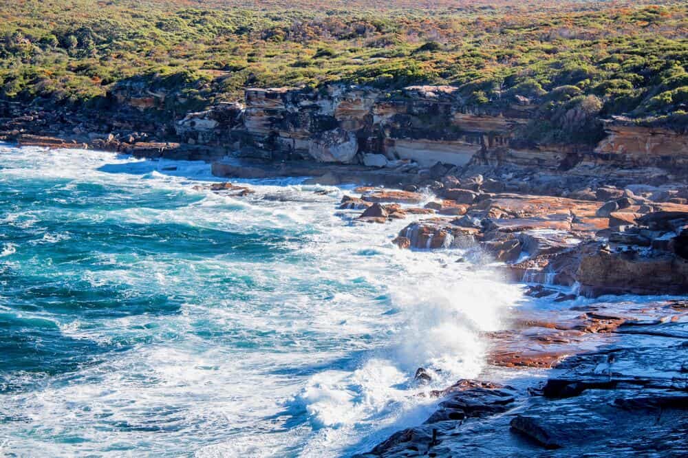 waves crashing into a rocky shoreline