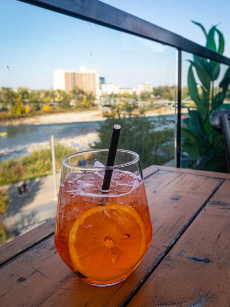 aperol spritz on table with river views behind