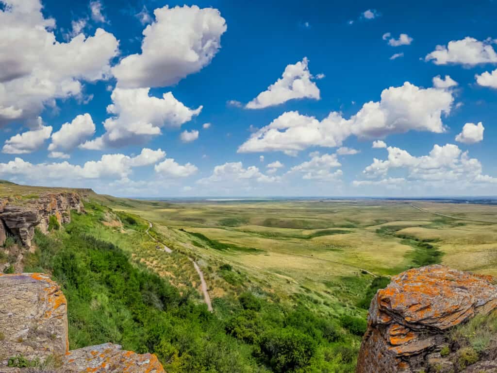 Beautiful aerial view of Canadian Prairie at Head-Smashed-In Buffalo Jump world heritage site in Southern Alberta on a sunny day with blue sky and clouds in summer