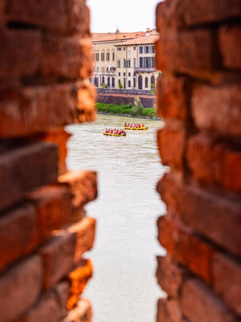 peeping through a brick window to rafters in the river