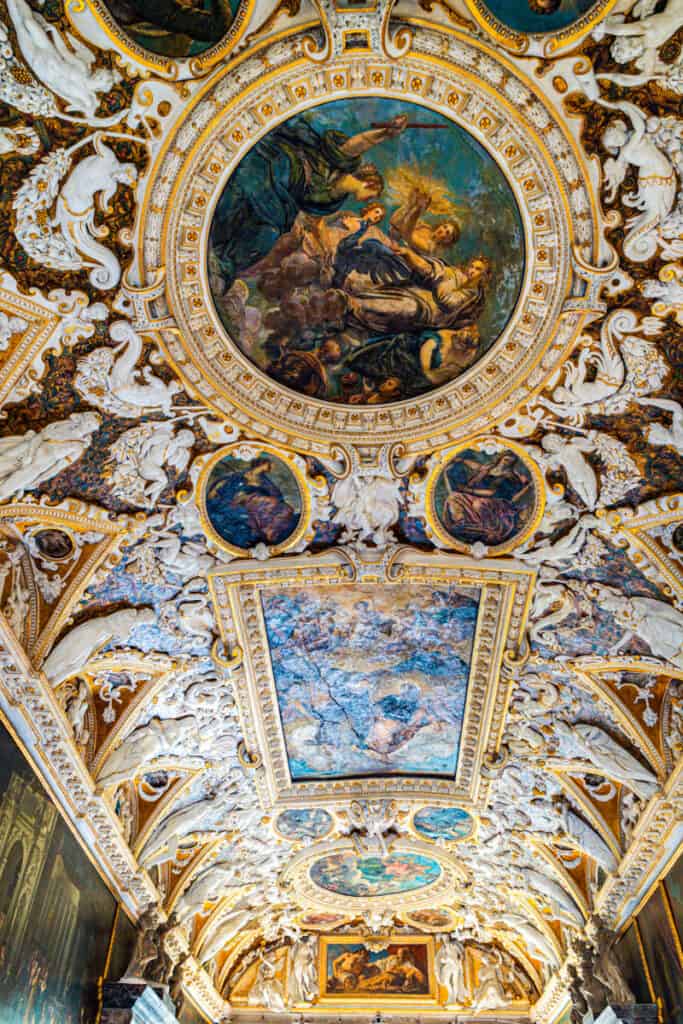 elaborately designed ceiling with paintings and stucco