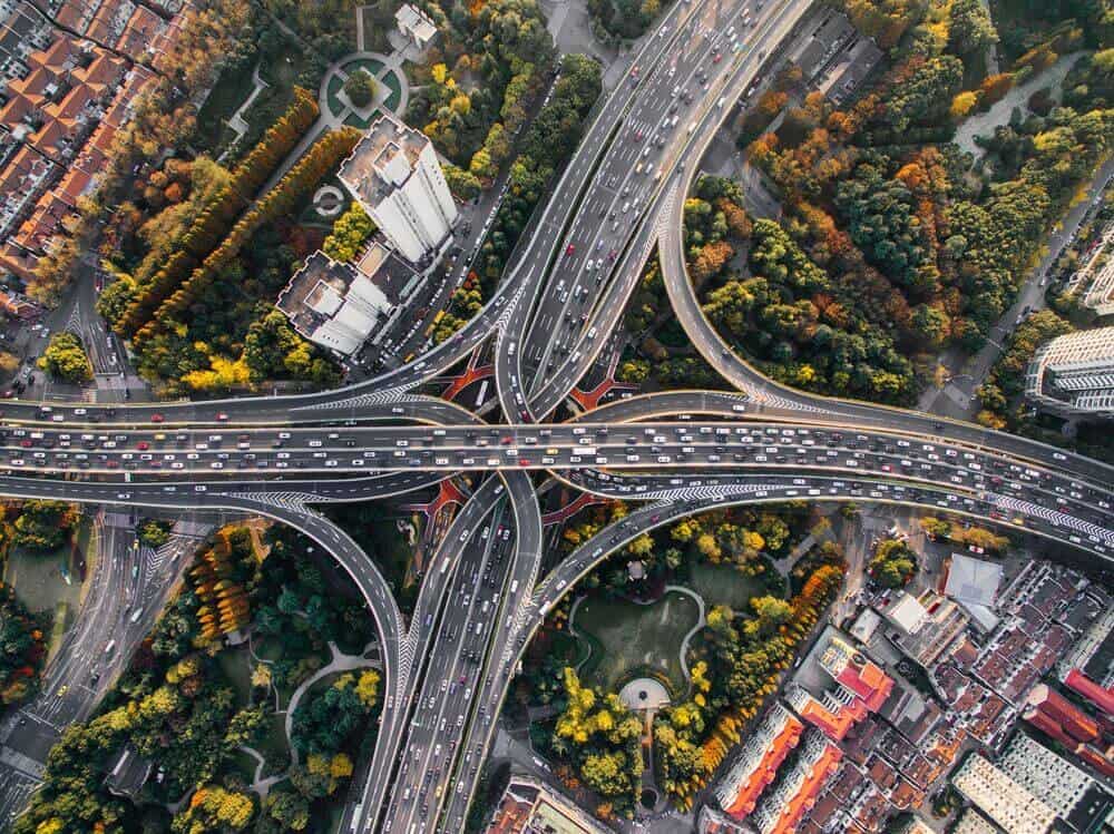 aerial view of roads filled with cars crisscrossing each other