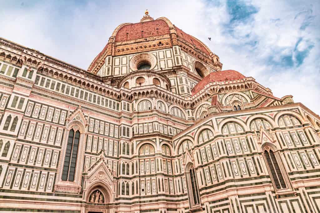 white, green and pink marble exterior of florence duomo and the orange top dome