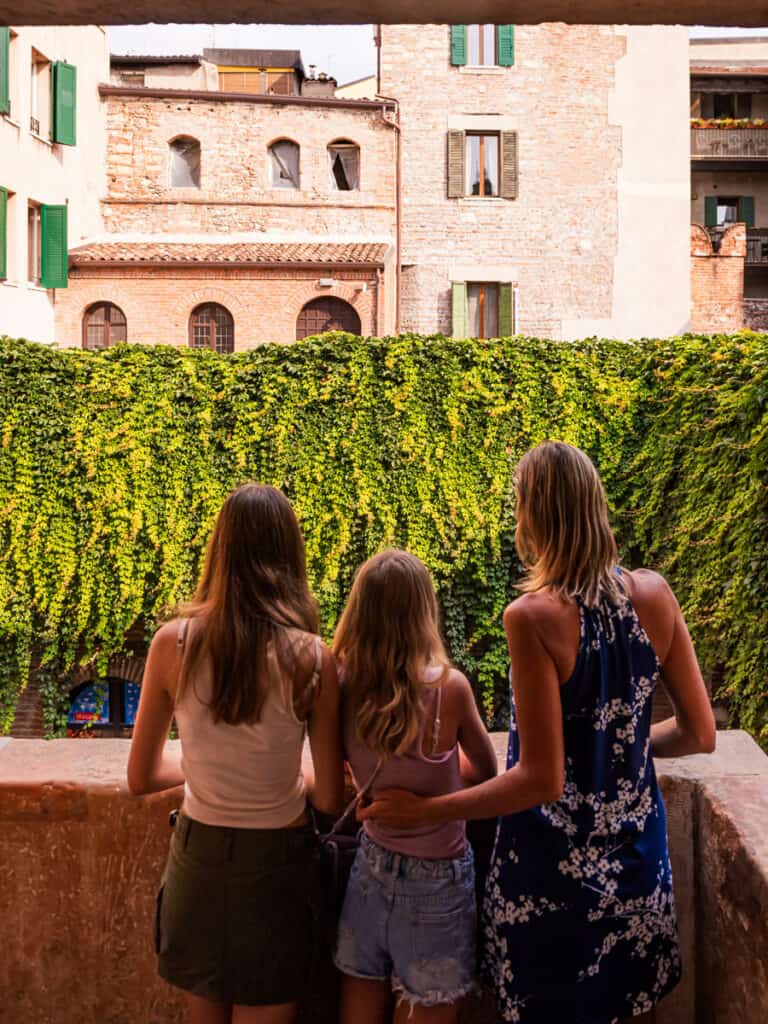 caz and girls on juliet balcony looking out
