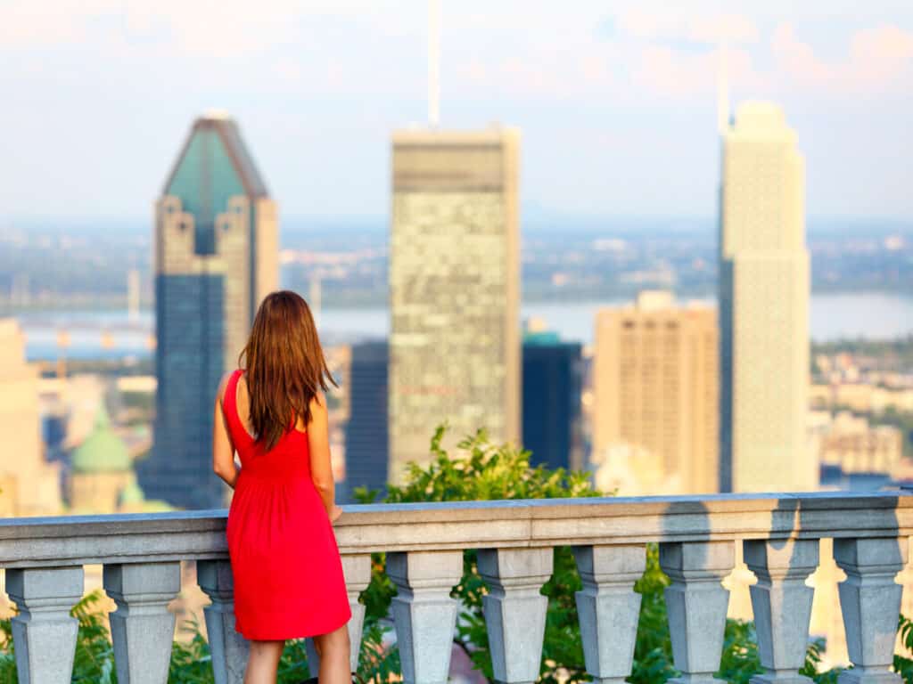 Woman in red dress looking at Montreal downtown skyline cityscape