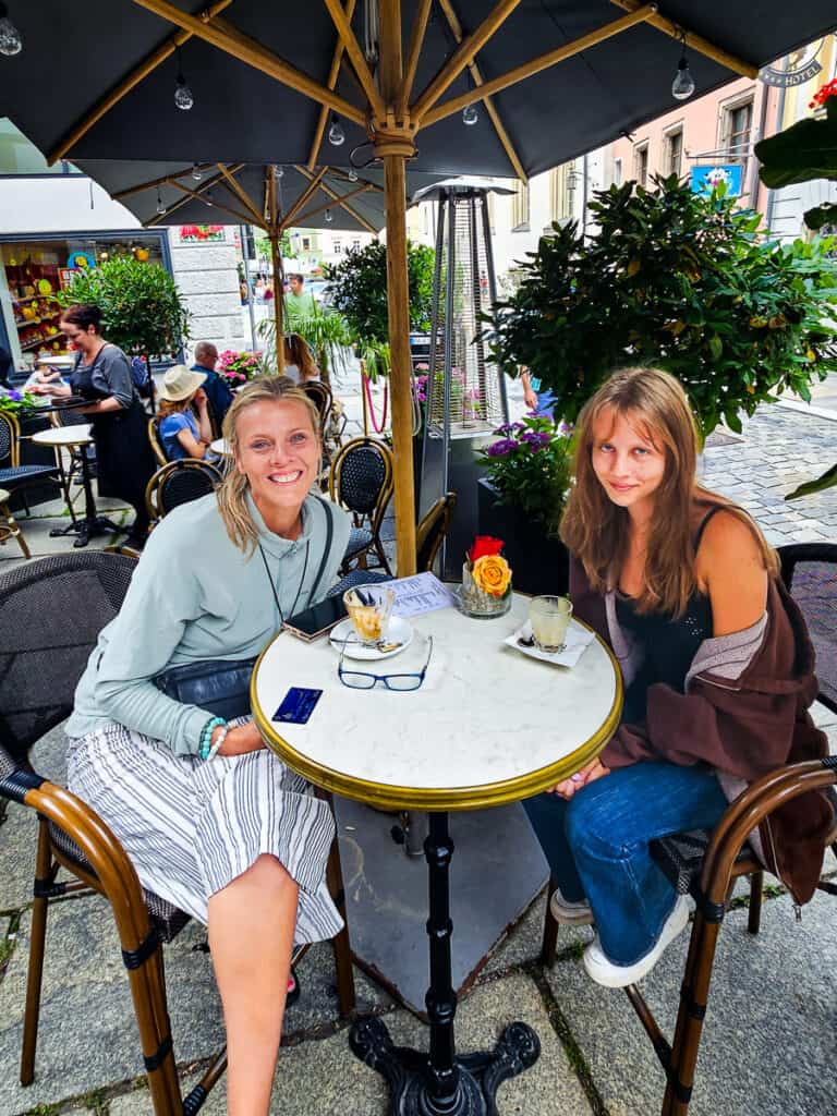 Mom and daughter sitting at a cafe in Passau, Germany