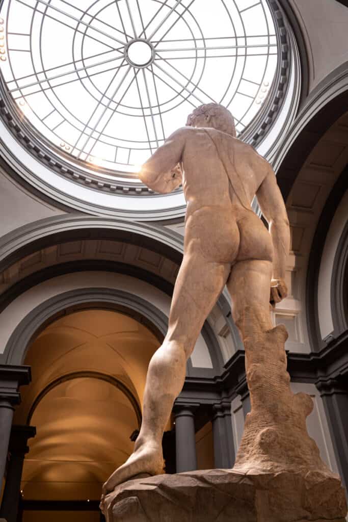 statue of david's backside with view of glass dome above