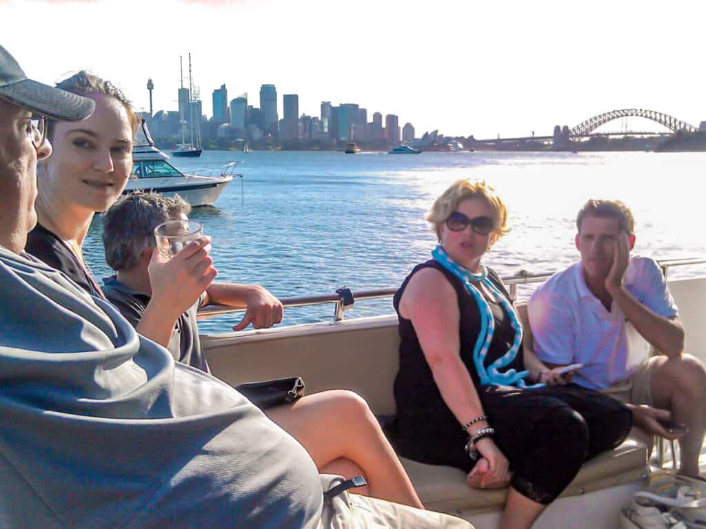 people sitting on boat on sydney harbour