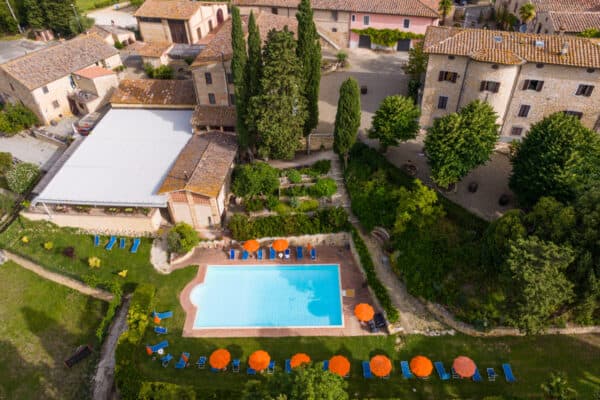 aerial view of tuscan farm and swimming pool